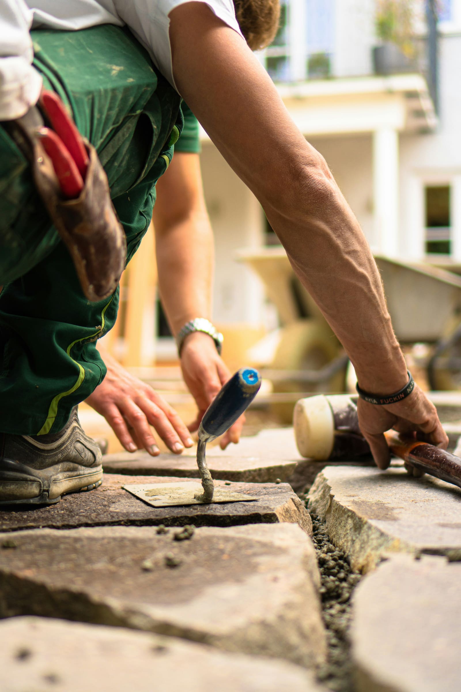 A mason setting a stone